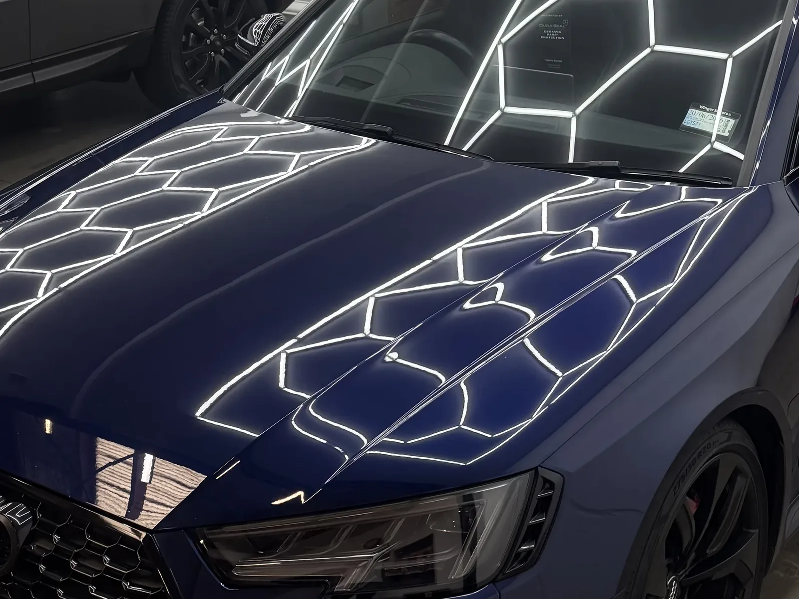Deep gloss reflections on a blue Audi RS bonnet after ceramic coating at Tiger Tint & Wrap